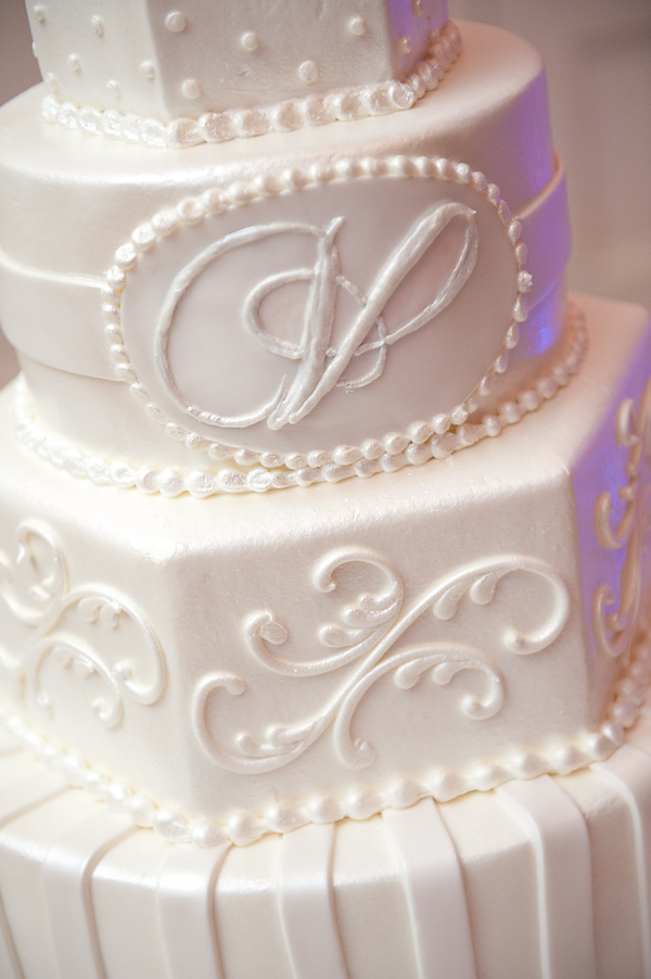 beautiful white details of white four tiered wedding cake - photo by Houston based wedding photographer Adam Nyholt